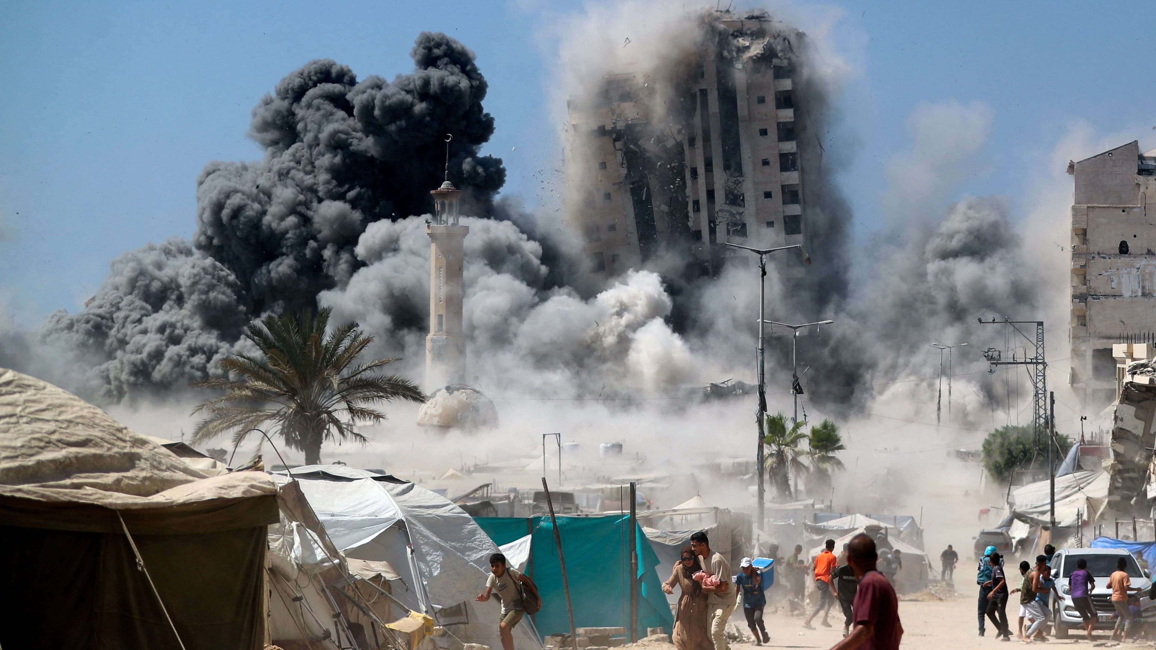 Israel levels high-rise building, threatens to strike more